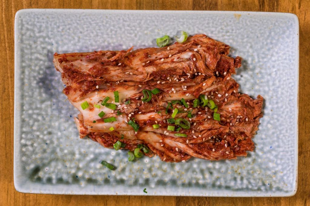 Fresh Korean kimchi seasoned with fish sauce, chili flakes, green onions and sesame seeds