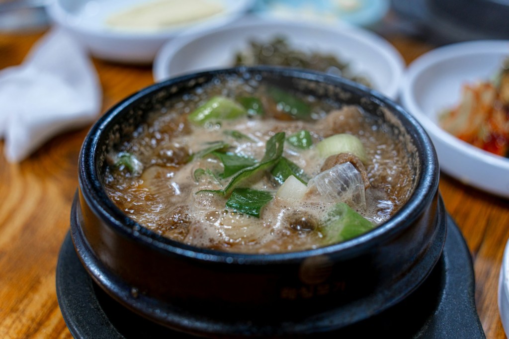 Hot, bubbling spicy Korean stew in an earthenware pot