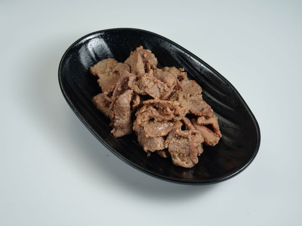 Thinly sliced beef bulgogi in a sweet soy marinade served in a black bowl