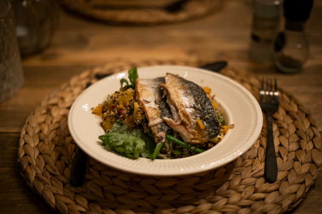 Cooked fish served on a white ceramic plate