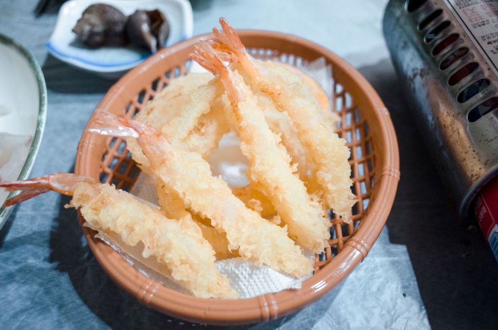 Crispy golden battered fried shrimp in a woven basket
