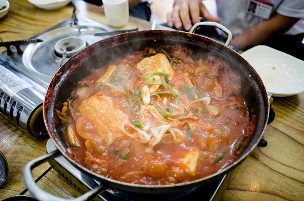 Spicy Korean fish stew simmering in a pan, seasoned with dadaegi chili paste