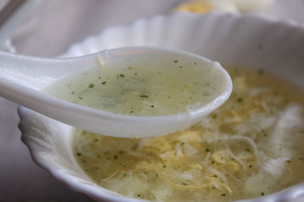 Light egg soup with silky egg ribbons in a white bowl
