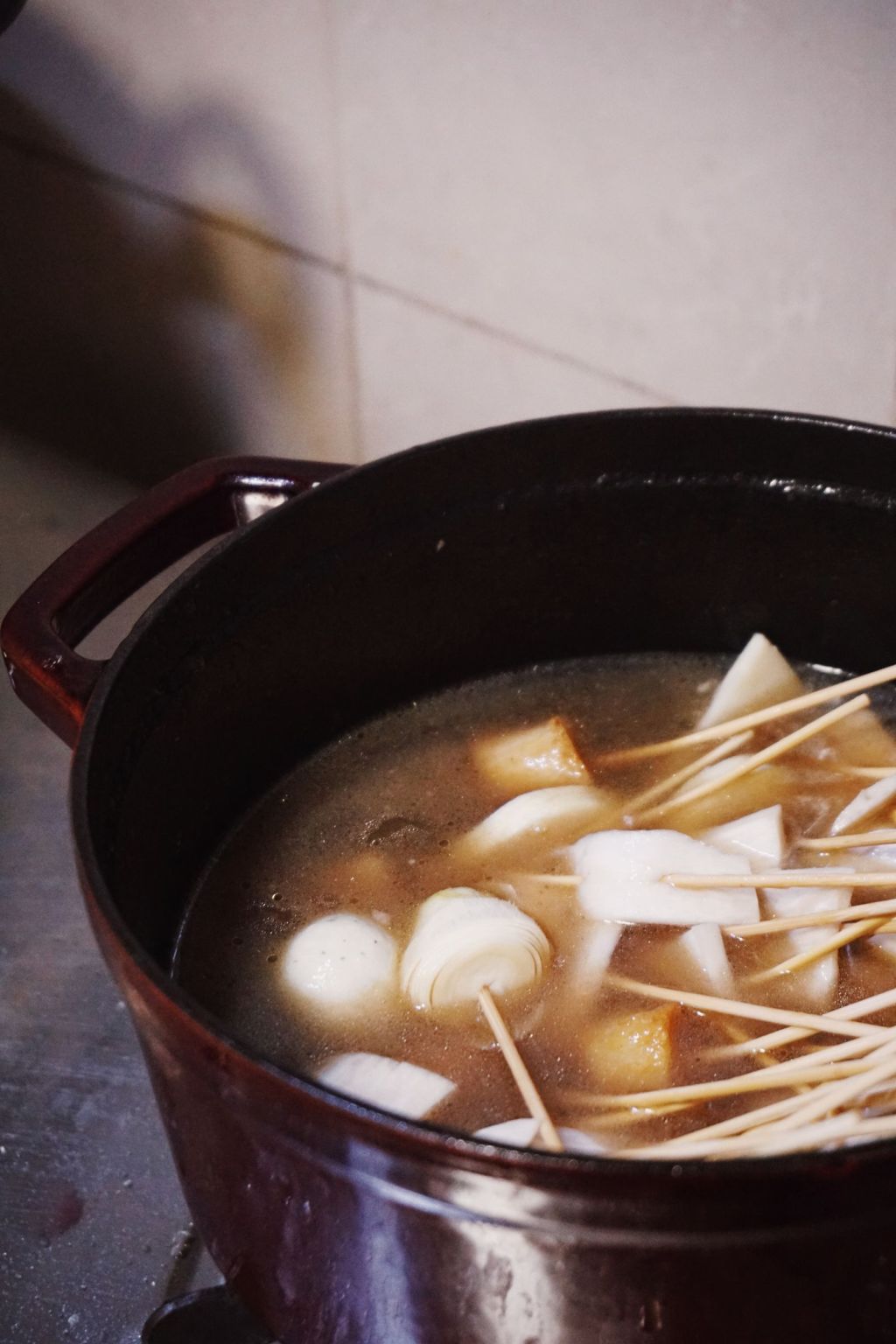 Fish cakes and other ingredients simmering in a pot of savory broth