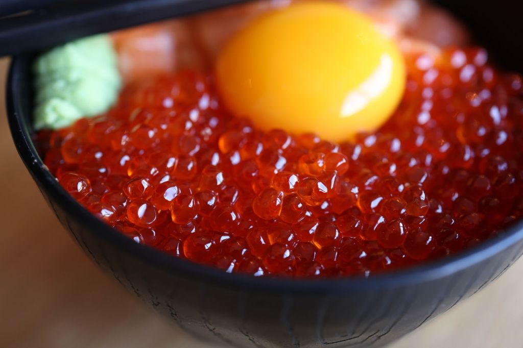 Rice bowl topped with salted fish roe and a raw egg yolk