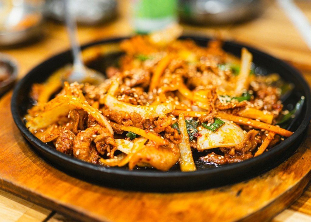 Spicy Korean pork stir-fry with sesame seeds, similar to jeyuk bokkeum