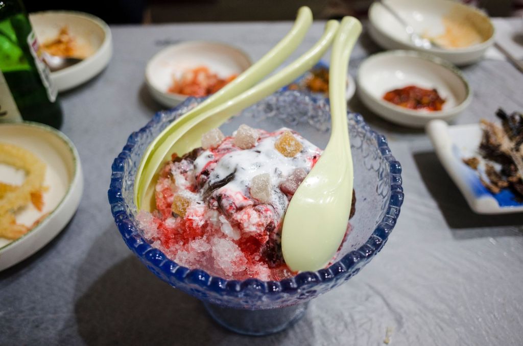 Korean bingsu shaved ice dessert with toppings and spoons