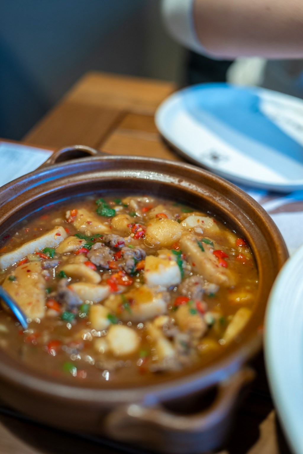 Hearty stew of meat and vegetables simmering in a ceramic pot