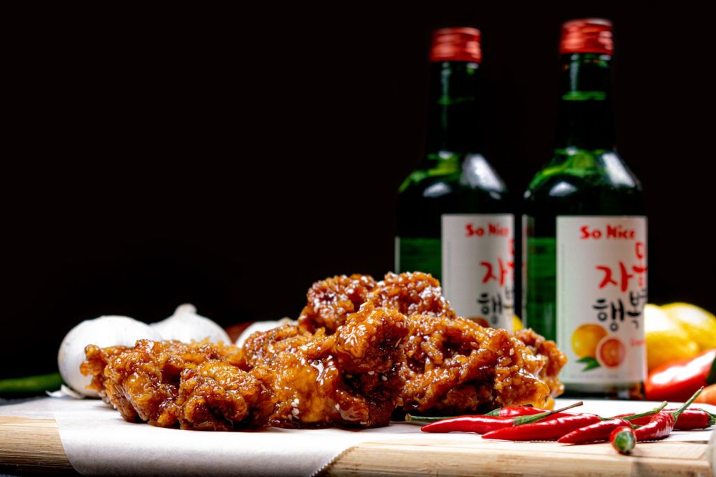 Crispy Korean fried chicken served chicken-shop style with chili peppers