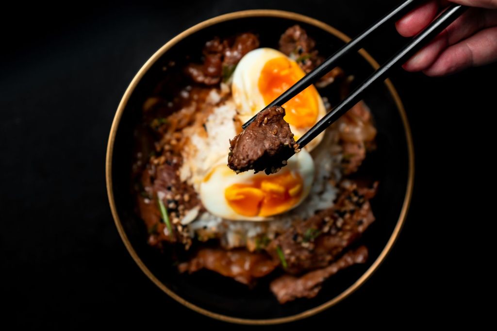 Soy-seasoned beef over rice with a soft-boiled egg, made with mat-ganjang