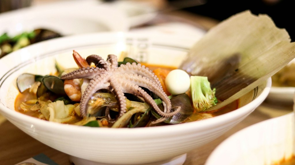Korean seafood dish with octopus served in a white bowl in Seoul