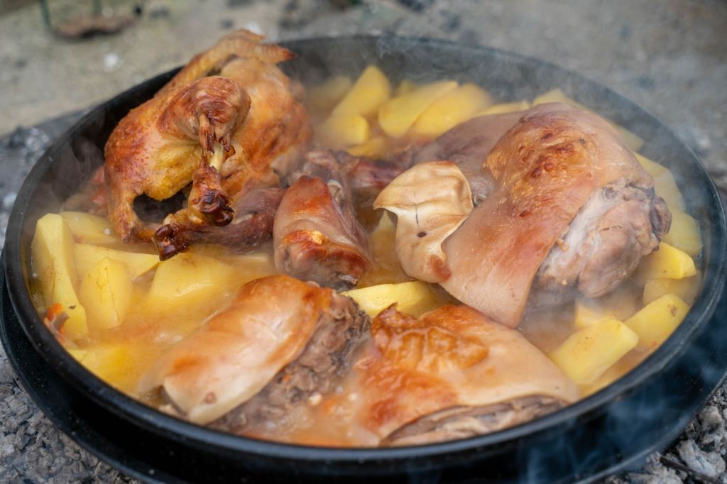 Soy-braised chicken with potatoes in a hot pan, similar to Korean jjimdak
