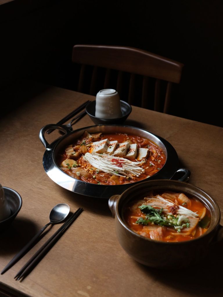 Korean hot pot (jeongol) with tofu, mushrooms and vegetables in broth