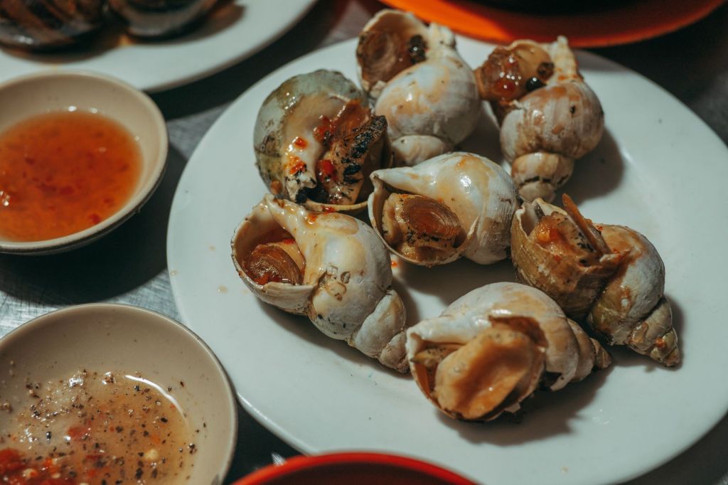 Cooked sea snails served with a spicy Korean-style dipping sauce