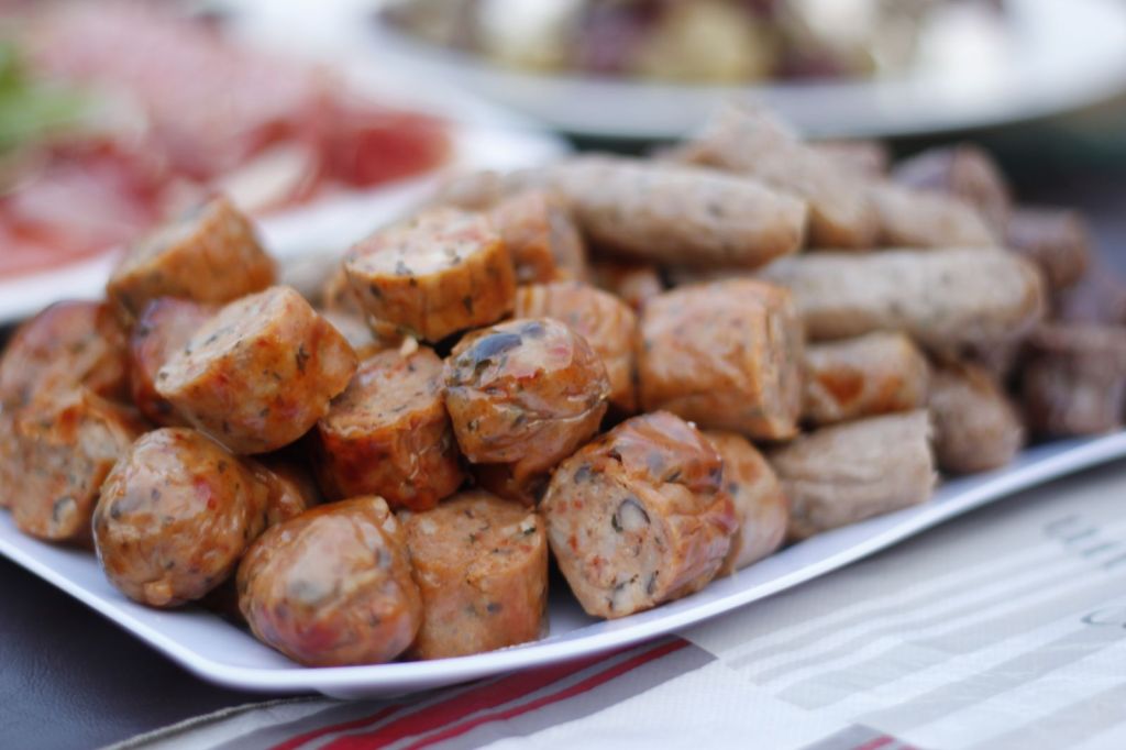 Cooked sliced sausages on a white plate