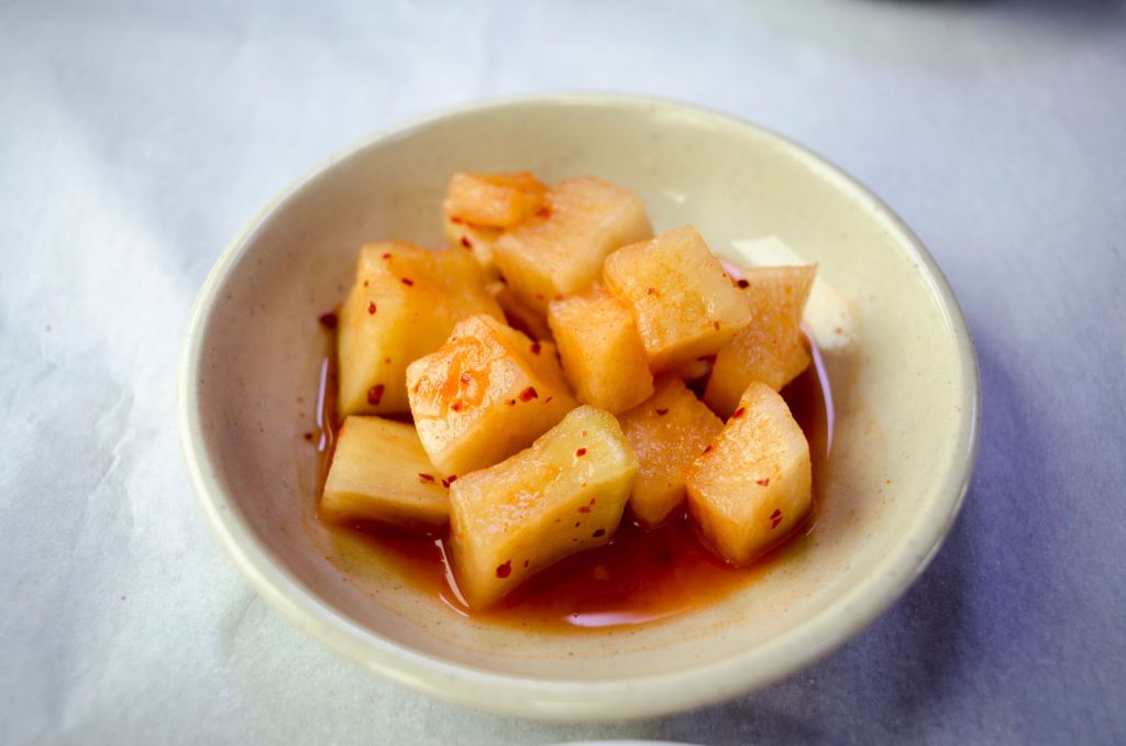 Bowl of kkakdugi, Korean cubed radish kimchi coated in red chili seasoning