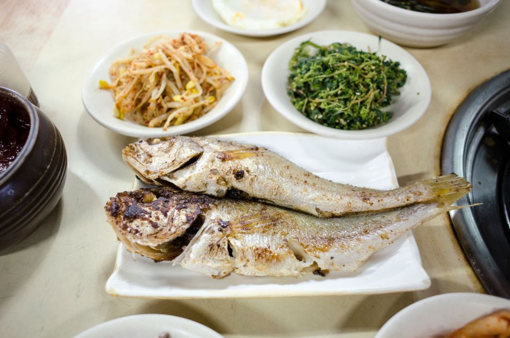 Korean grilled fish served with rice and banchan side dishes