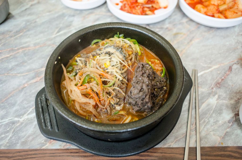 Korean haejangguk hangover soup with vegetables in a black pot