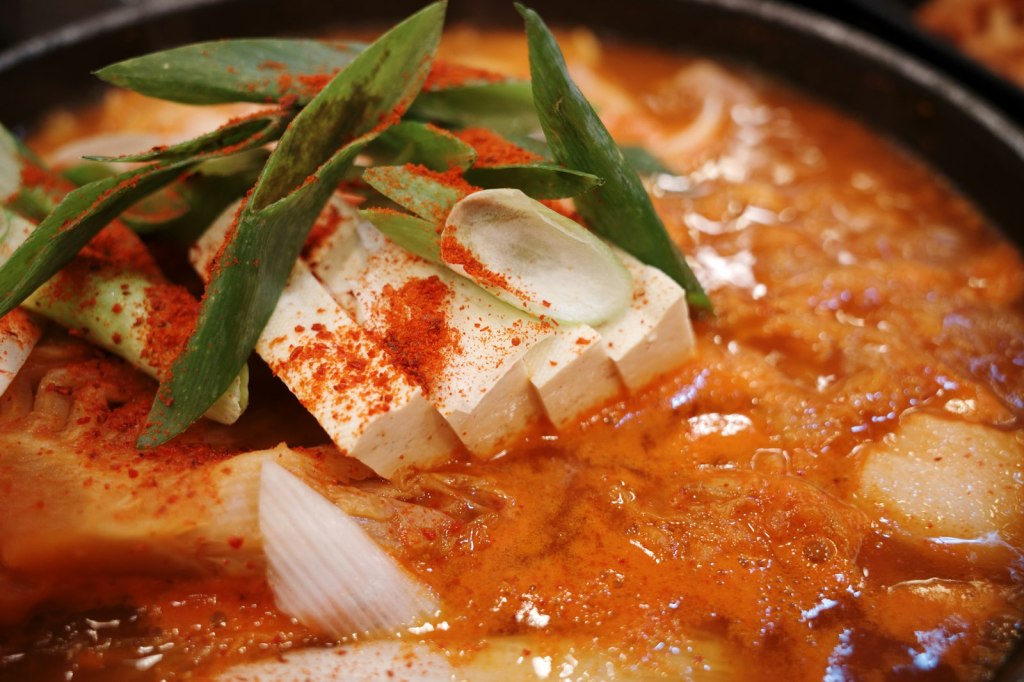 Bubbling Korean stew with tofu and scallions in a pot