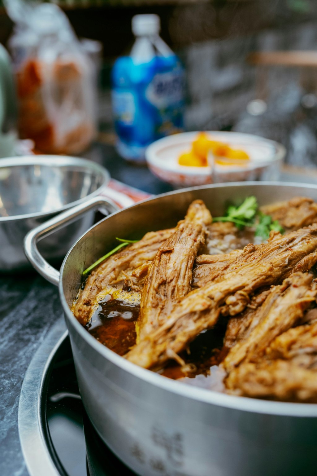 Close-up of tender braised meat in a pot of glossy savory sauce, similar to Korean galbi-jjim