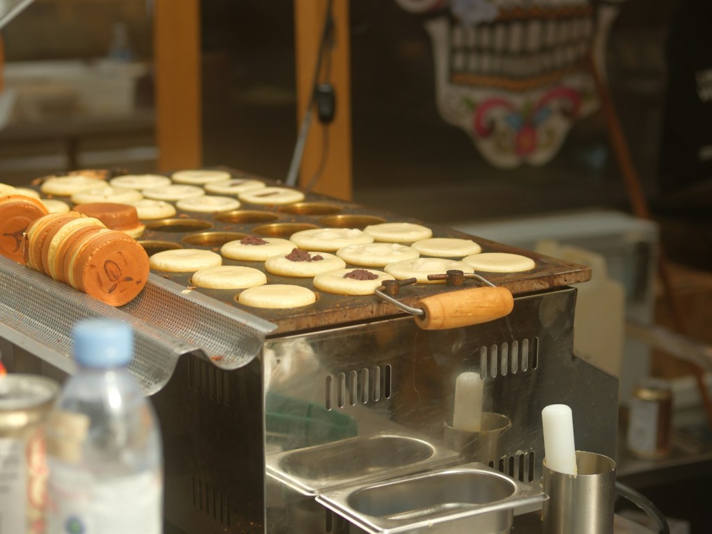 Round sweet pancakes cooking on a hot griddle